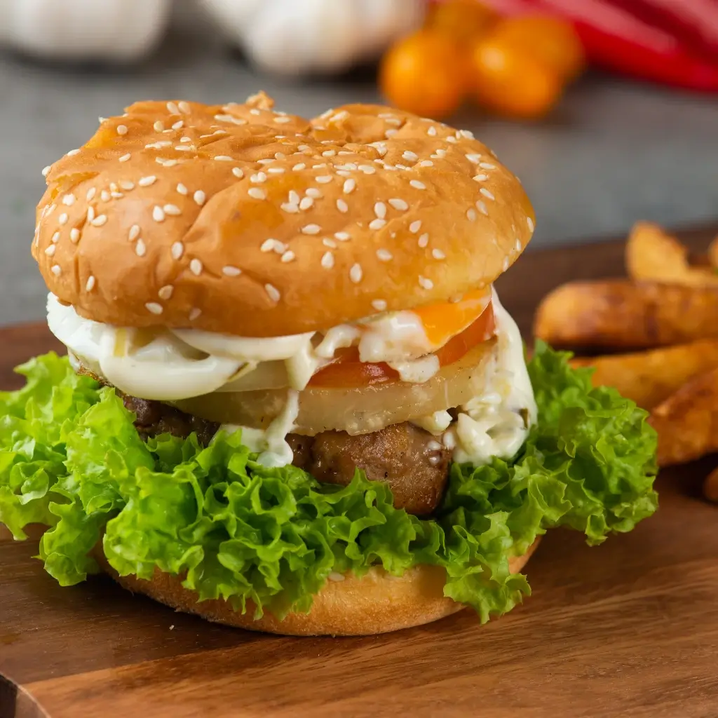 A close-up of a Hello Fresh burger with melted cheese, fresh toppings, and a rustic background.